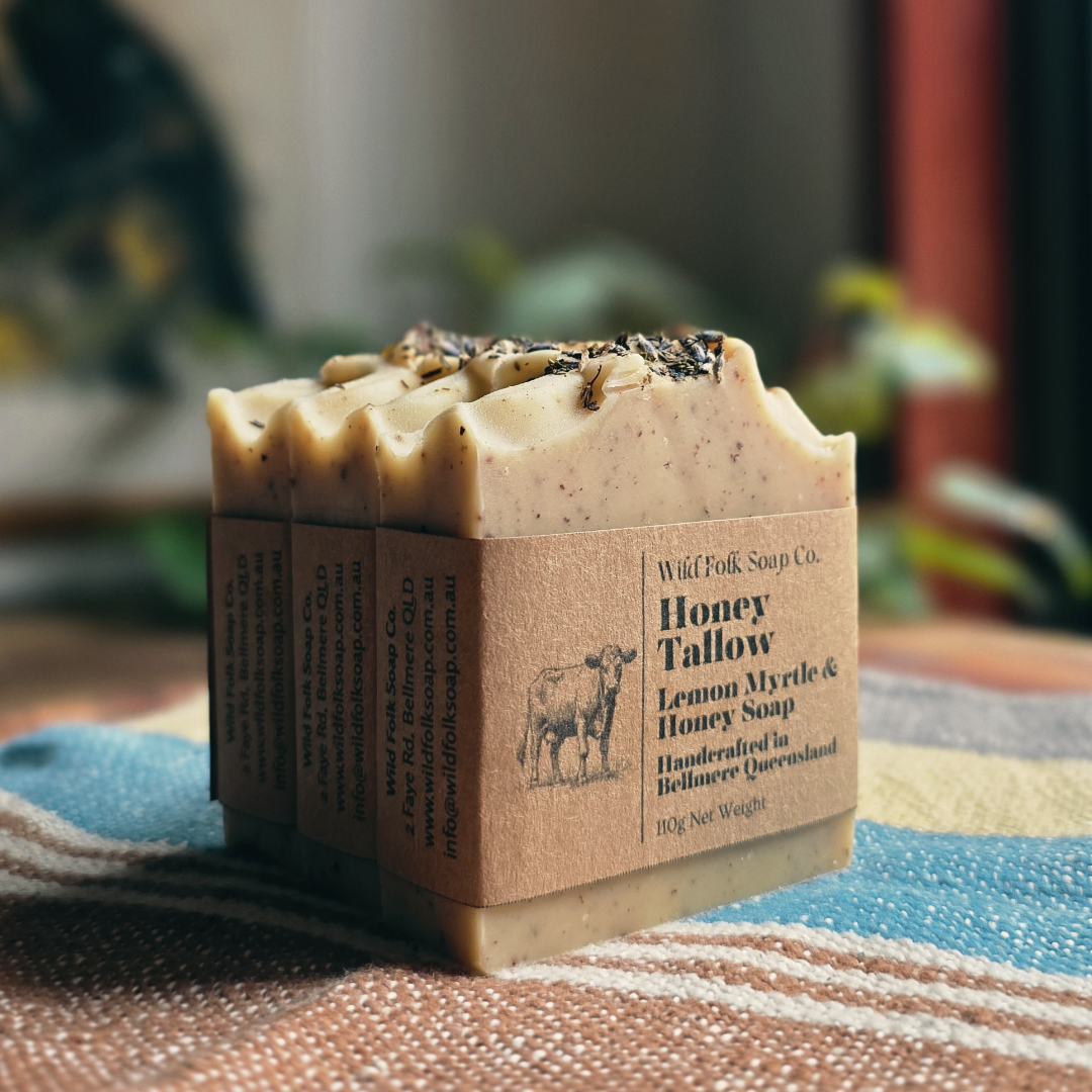 Bar of soap with a brown packaging label on a textured surface with a blurred natural background