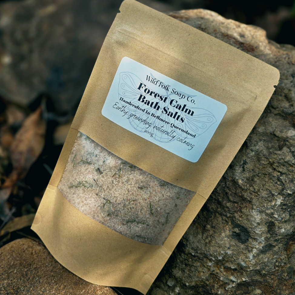 Bag of Forest Calm Bath Salts from Wild Folk Soap Co. on a stone surface
