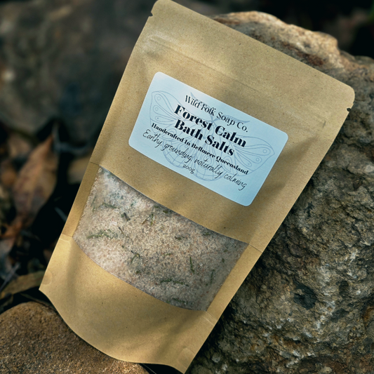 Bag of Forest Calm Bath Salts from Wild Folk Soap Co. on a stone surface
