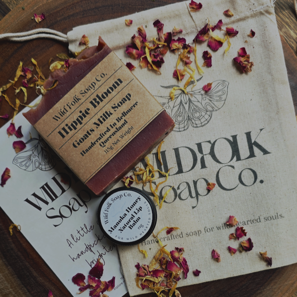 Bar of soap with a label on a Wildfolk Soap Co. branded paper with dried flowers.