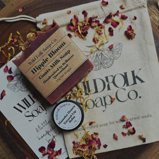Bar of soap with a label on a Wildfolk Soap Co. branded paper with dried flowers.