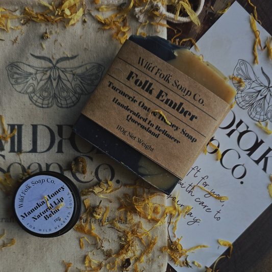 Bar of soap and lip balm from Wild Folk Soap Co. on a rustic background with dried flowers.