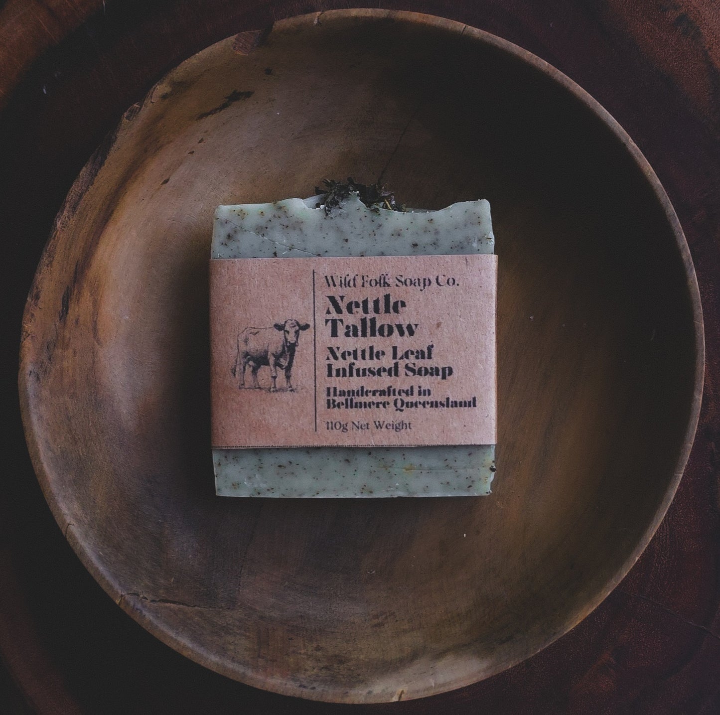Nettle Tallow handmade cold process tallow soap made with Australian grass-fed beef tallow, nettle and pure essential oils on a rustic wooden surface by Wild Folk Soap Co.
